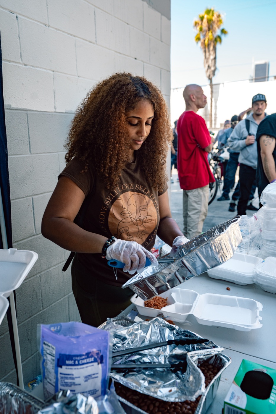 PACK Project volunteer prepping food