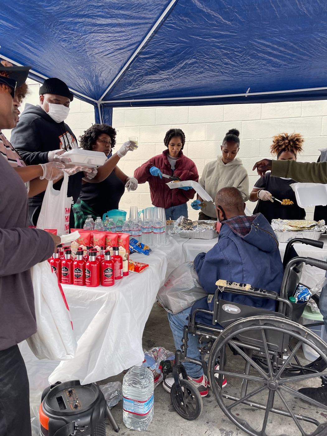 PACK Project volunteers serving a community member